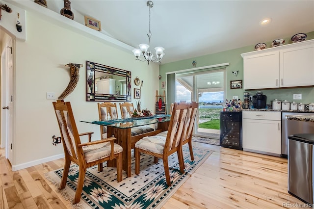 dining space featuring wine cooler, light hardwood / wood-style floors, and a notable chandelier