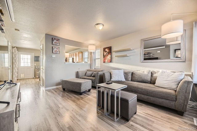 living room with hardwood / wood-style floors and a textured ceiling