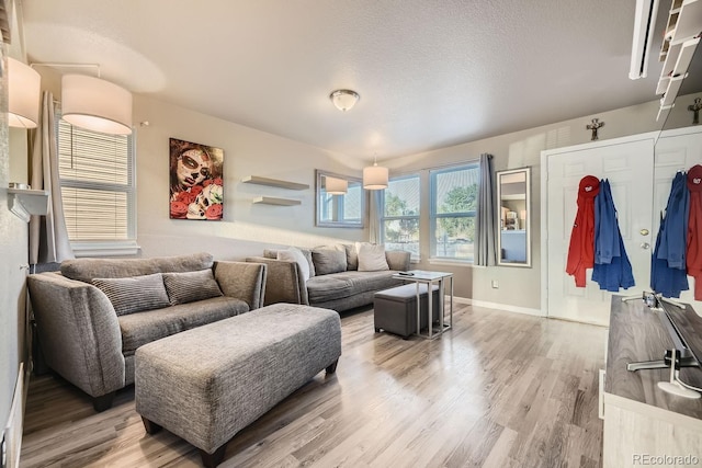 living room featuring a textured ceiling and hardwood / wood-style flooring