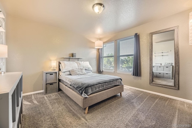 carpeted bedroom featuring a textured ceiling