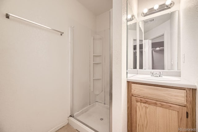 bathroom featuring vanity and an enclosed shower