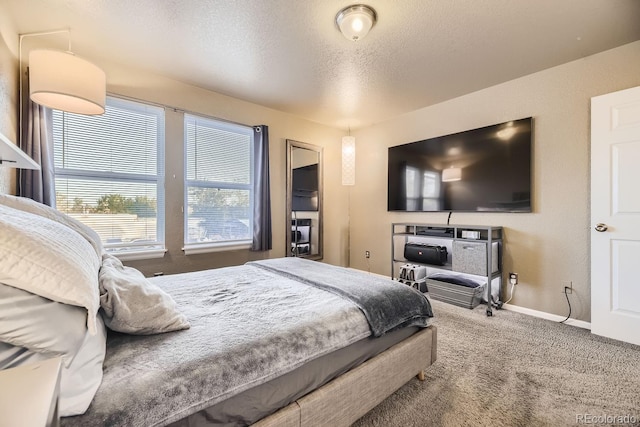 bedroom featuring carpet floors and a textured ceiling