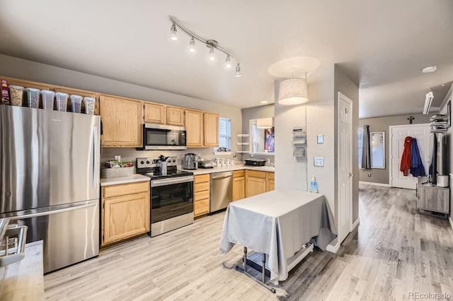 kitchen featuring appliances with stainless steel finishes, light hardwood / wood-style floors, and light brown cabinetry