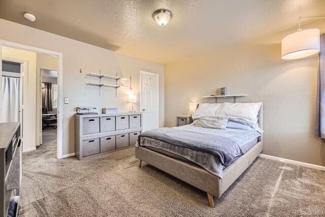 bedroom featuring carpet and a textured ceiling