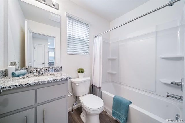 full bathroom with vanity, hardwood / wood-style floors, shower / bathtub combination with curtain, and toilet