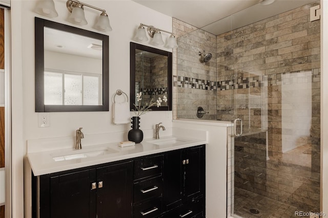 bathroom with double vanity, a sink, and a shower stall