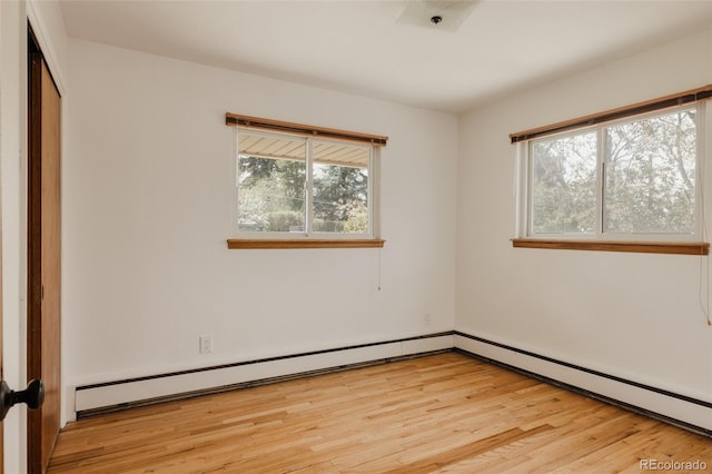 unfurnished room with light wood-style flooring