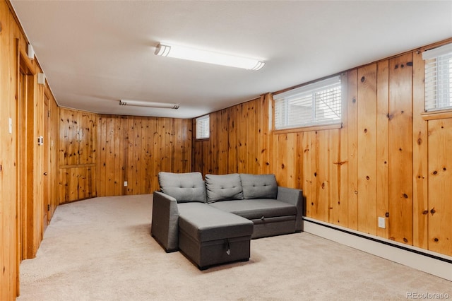 carpeted living area featuring wood walls and a baseboard heating unit