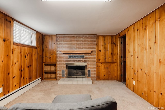 unfurnished living room with carpet floors, wooden walls, baseboard heating, and a fireplace