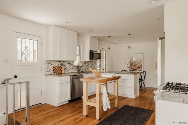 5700 E Floyd Ave, Denver, CO 80222 - kitchen featuring dishwasher, light wood-style floors, white cabinets, backsplash, and recessed lighting