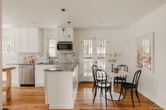 5700 E Floyd Ave, Denver, CO 80222 - kitchen featuring appliances with stainless steel finishes, a sink, white cabinetry, stone counters, and recessed lighting