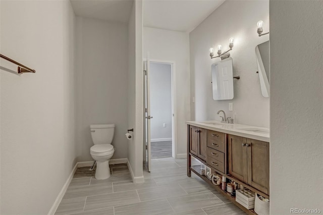 bathroom with toilet and vanity