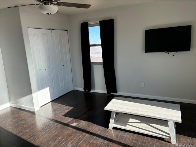 unfurnished bedroom featuring ceiling fan, dark hardwood / wood-style floors, and a closet