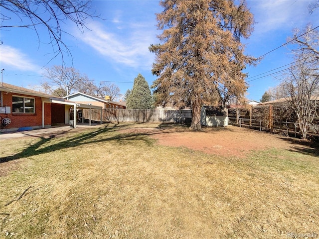 view of yard with an outbuilding and a fenced backyard