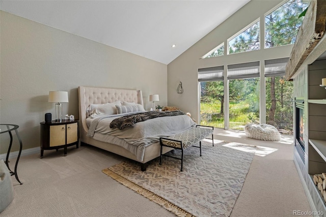 bedroom featuring light carpet and high vaulted ceiling