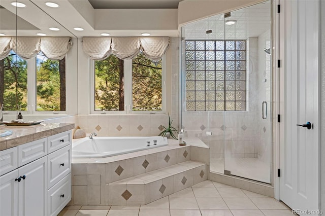 bathroom with tile patterned flooring, plus walk in shower, and vanity