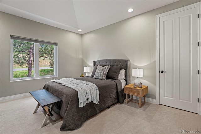 bedroom with lofted ceiling and light carpet