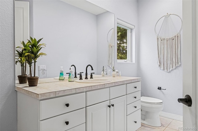 bathroom with tile patterned floors, vanity, and toilet