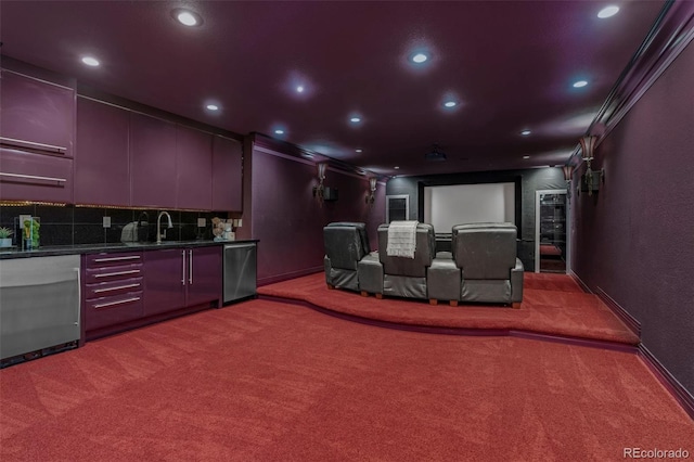 carpeted home theater featuring sink and crown molding