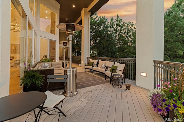 deck at dusk with an outdoor hangout area