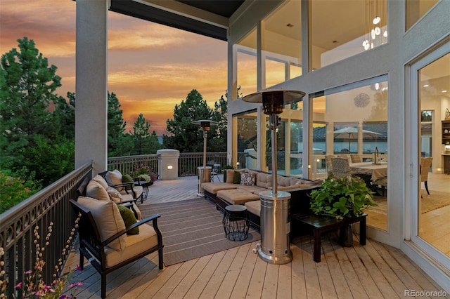 deck at dusk with an outdoor hangout area