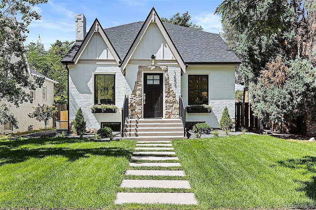 english style home with a front yard