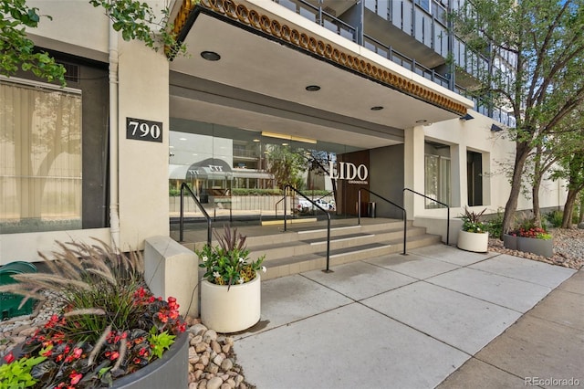 790 N Washington St Unit 407, Denver, CO 80203 - doorway to property with stucco siding and a porch