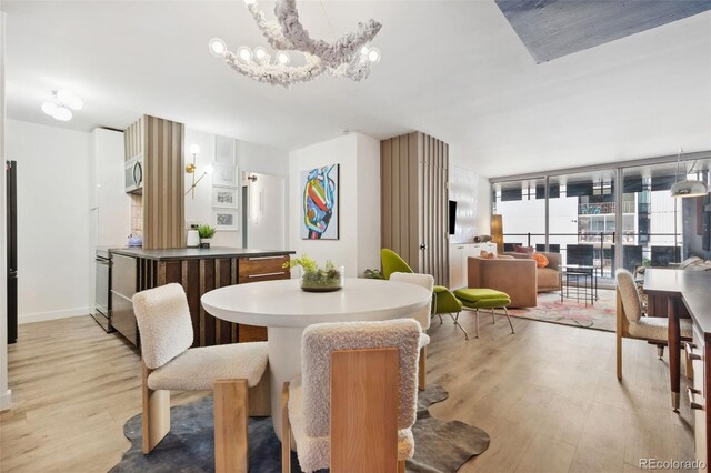 790 N Washington St Unit 407, Denver, CO 80203 - dining space with light wood-style flooring and a chandelier