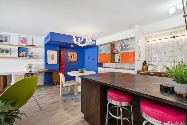 790 N Washington St Unit 407, Denver, CO 80203 - bar featuring a chandelier and wood finished floors
