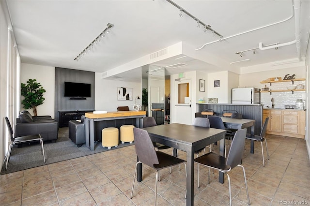 790 N Washington St Unit 407, Denver, CO 80203 - dining space with track lighting and light tile patterned floors