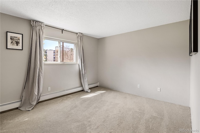 carpeted empty room featuring a textured ceiling