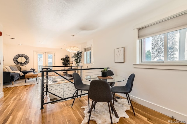 2837 Vallejo St Unit 102, Denver, CO 80211 - dining area with healthy amount of natural light, light wood-style floors, and french doors