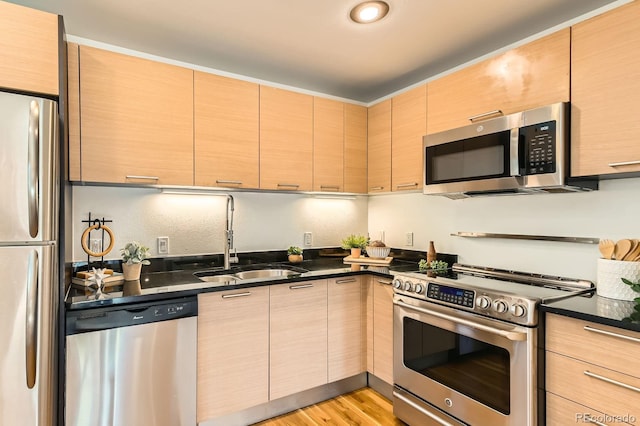 2837 Vallejo St Unit 102, Denver, CO 80211 - kitchen with stainless steel appliances, light brown cabinets, and modern cabinets