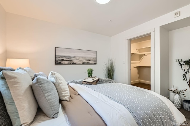 2837 Vallejo St Unit 102, Denver, CO 80211 - bedroom featuring baseboards and a walk in closet