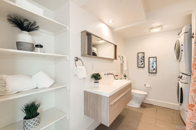 2837 Vallejo St Unit 102, Denver, CO 80211 - bathroom with stacked washer and clothes dryer, vanity, and tile patterned floors