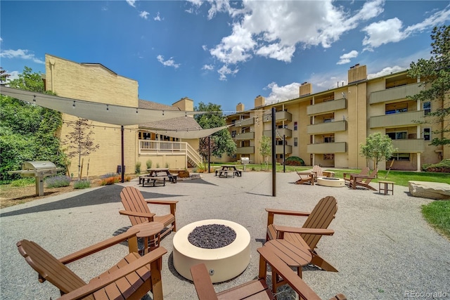 surrounding community with a patio and a fire pit