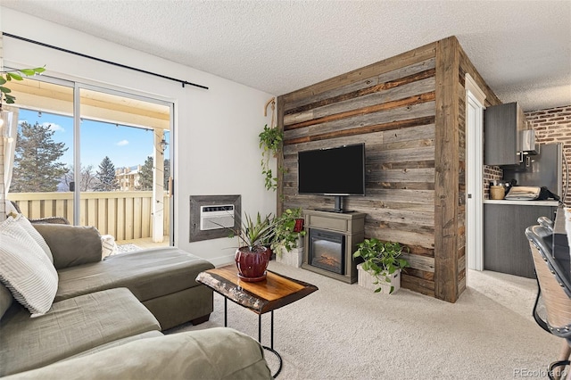 carpeted living room featuring wood walls, a textured ceiling, and a wall unit AC