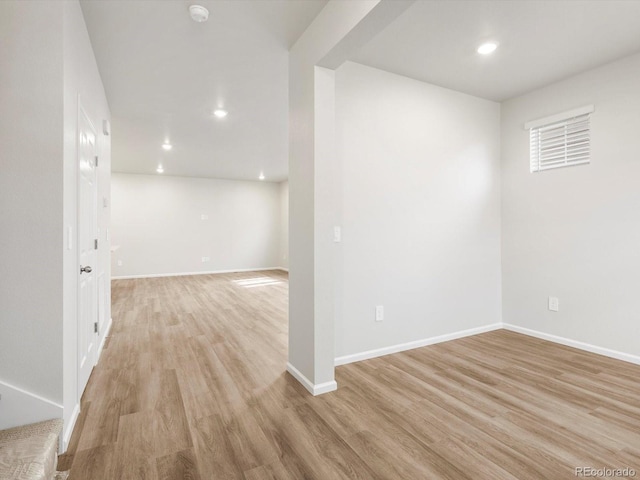 below grade area with recessed lighting, baseboards, and light wood-style floors