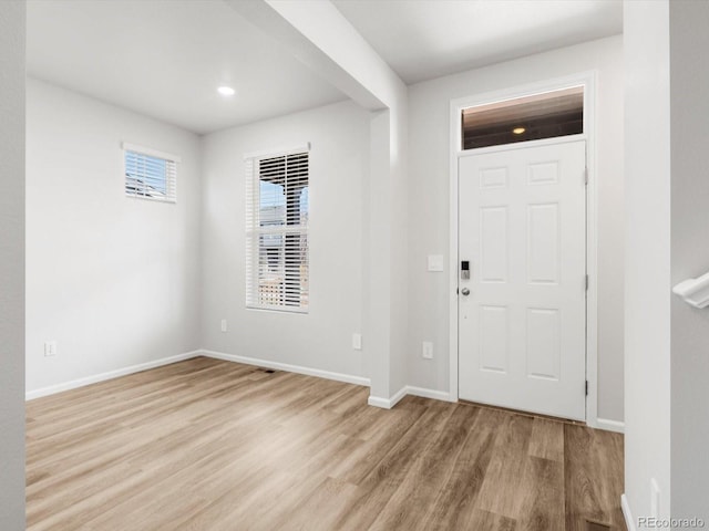 entrance foyer with baseboards and wood finished floors