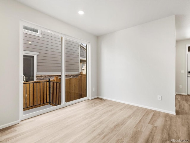 spare room with baseboards, recessed lighting, and wood finished floors