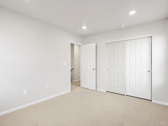 unfurnished bedroom with a closet, baseboards, carpet flooring, and recessed lighting