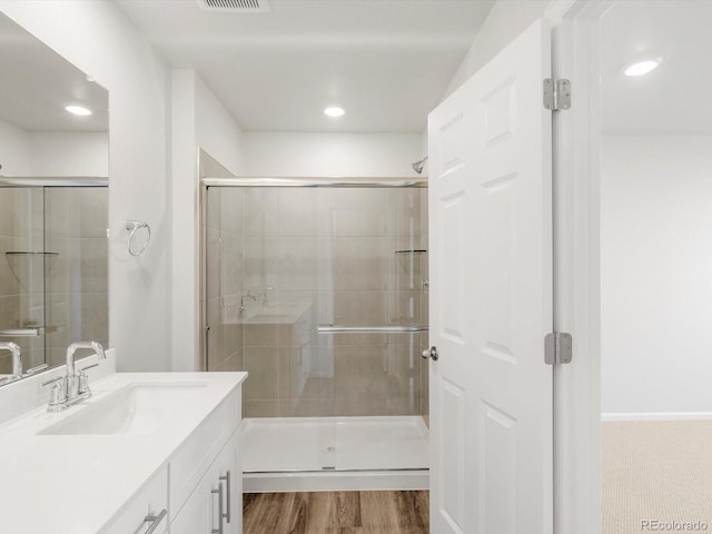 full bathroom with vanity, recessed lighting, a stall shower, and visible vents