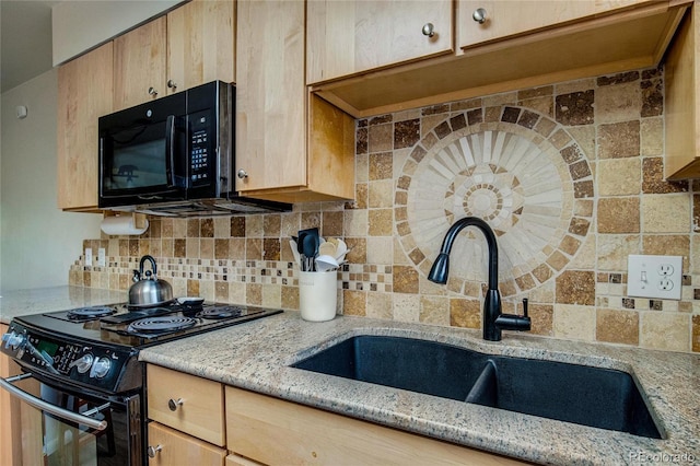 kitchen with light brown cabinets, black appliances, sink, tasteful backsplash, and light stone counters