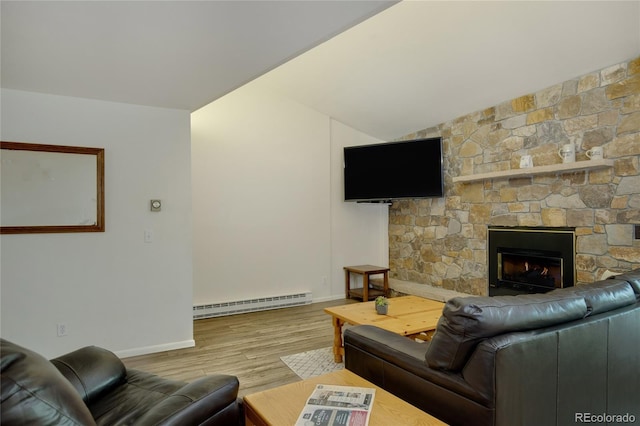 living room featuring a fireplace, hardwood / wood-style floors, and a baseboard radiator