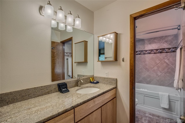 full bathroom with vanity, toilet, and tiled shower / bath combo