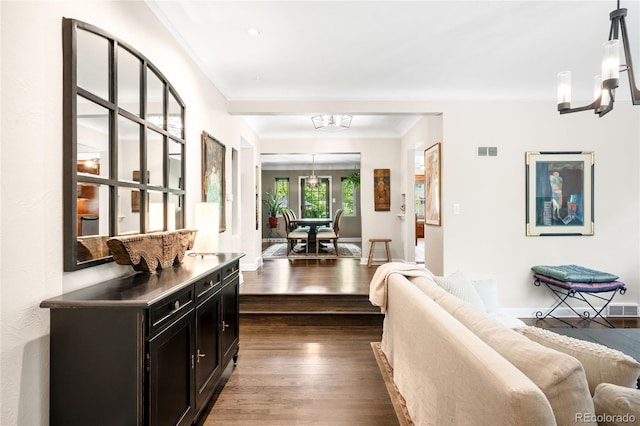 628 Cherry St, Denver, CO 80220 - corridor with a chandelier, dark wood finished floors, crown molding, and baseboards