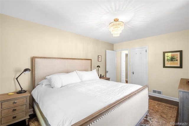 628 Cherry St, Denver, CO 80220 - bedroom featuring baseboards, dark wood-style flooring, and a chandelier