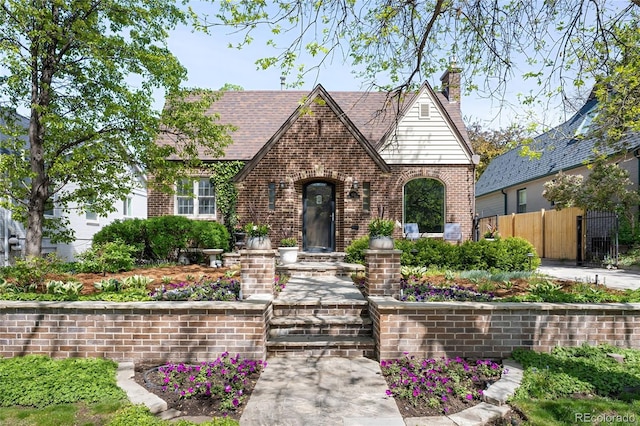 628 Cherry St, Denver, CO 80220 - english style home with brick siding, fence, and a chimney