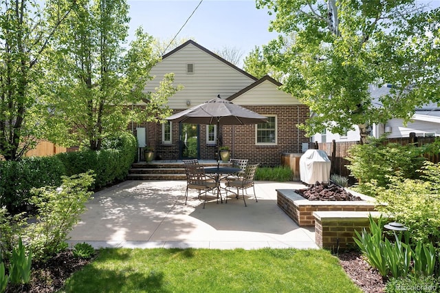 628 Cherry St, Denver, CO 80220 - back of house featuring brick siding, fence, and a patio area