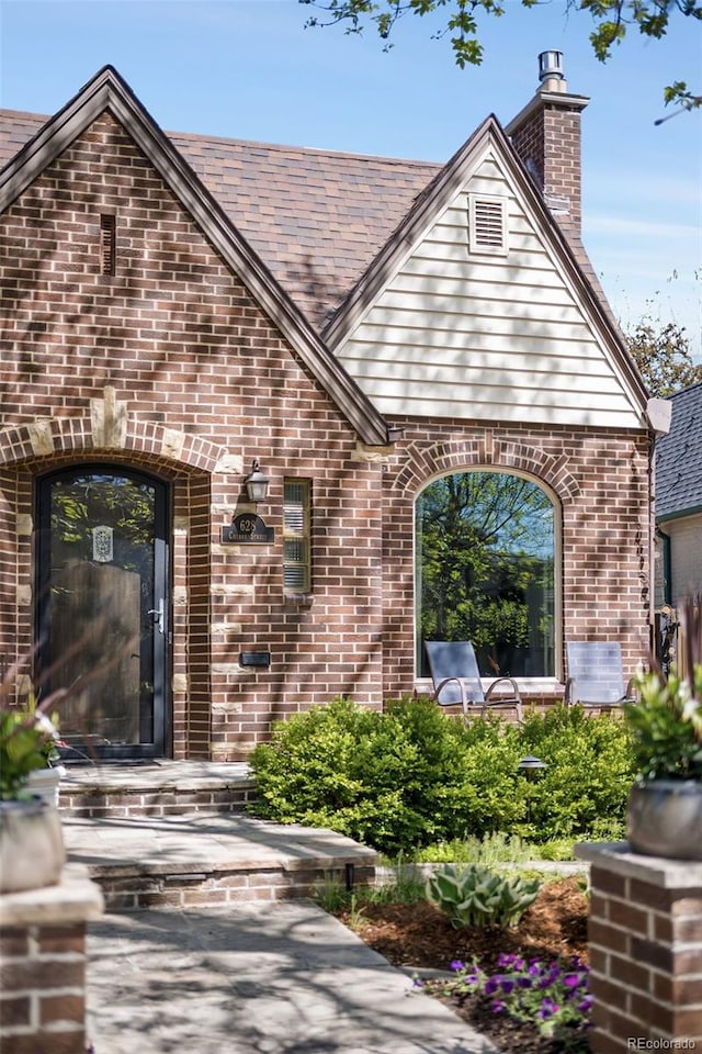 628 Cherry St, Denver, CO 80220 - property entrance with brick siding and a chimney